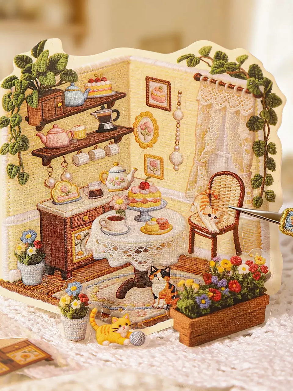 Close-up of the printed yarn-style artwork on a Tiny Worlds scene card